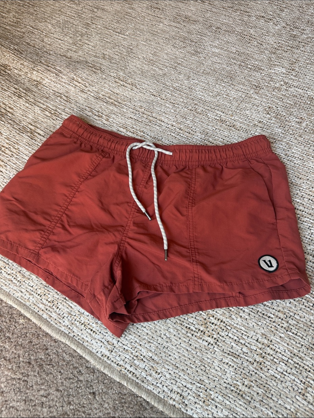 Vuori Women's Athletic Shorts in Rust Red